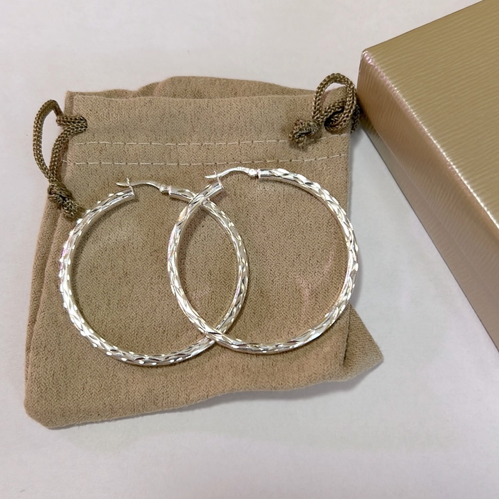 NWT Stirling Silver Diamond cut tube hoop earrings.